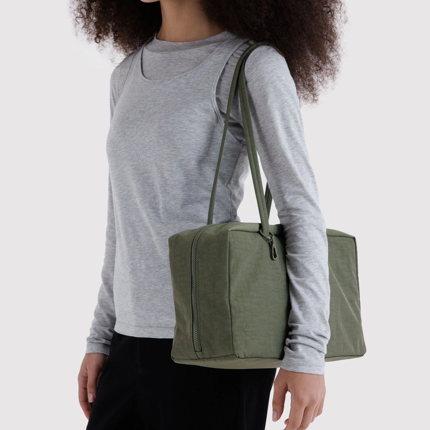 Olive green medium nylon bowler bag carried on shoulder strap with zip top