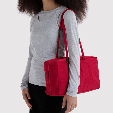 Cherry red medium nylon bowler bag with two top handles, carry on the shoulder