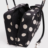 Medium nylon bowler bag in black with cream polka dots, side zippers and metal clasp