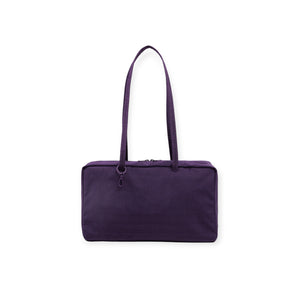 Deep purple rectangular fabric handbag with long dual straps and top zipper closure on white background