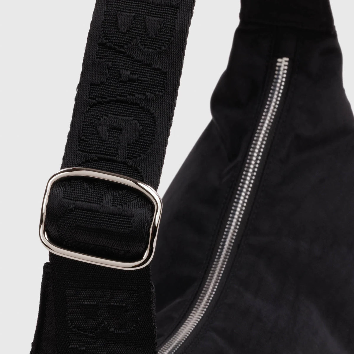Nylon crescent bag strap with adjustable buckle and studded band