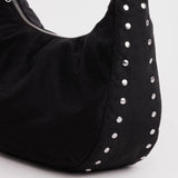 Black nylon crescent bag with row of silver studs on side panel