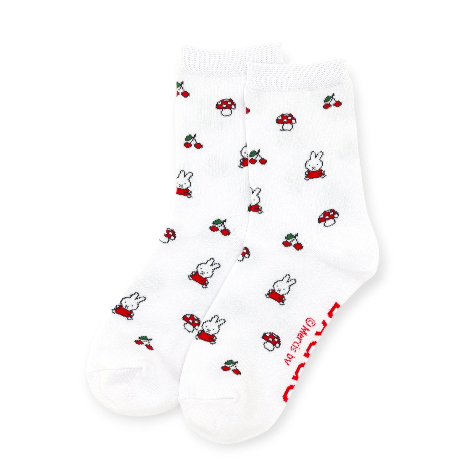 The Baggu Miffy x Baggu Crew Sock in white features small prints of rabbits, red mushrooms, and cherries, plus playful red text on the sole for a cute and fun style.