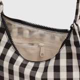 Black-and-cream gingham bag interior with zip top and logo pull