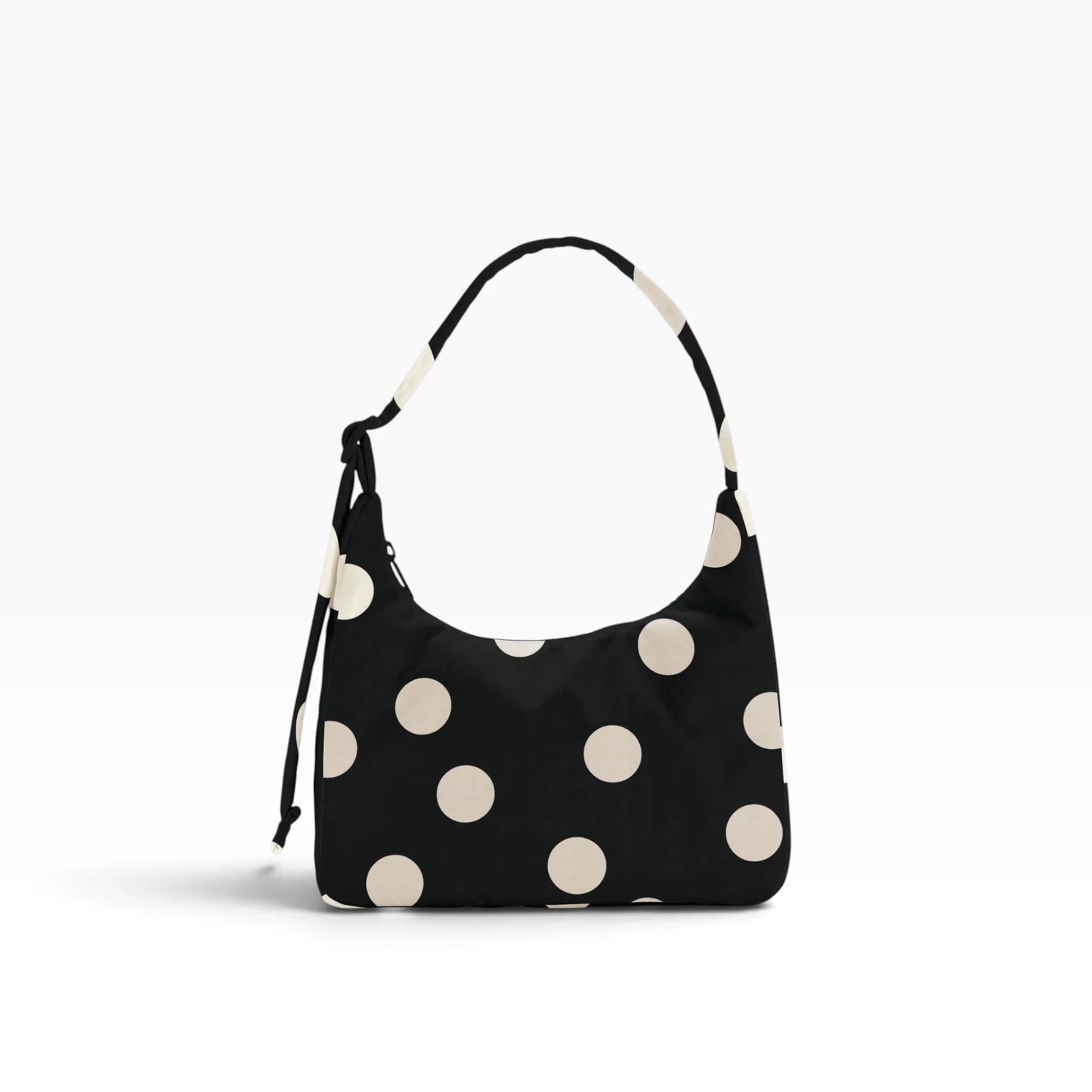 Black mini shoulder bag with cream polka dots and drawstring shoulder strap