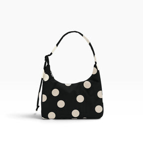 Black mini shoulder bag with cream polka dots and drawstring shoulder strap