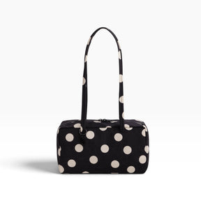 Black nylon bowler bag with cream polka dots, top handles, front zipper pocket.