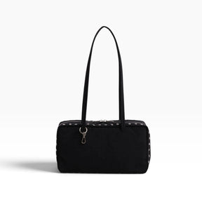 Black nylon bowler bag with studded trim and top handles, front zipper pocket