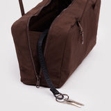 Brown rectangular fabric bag with dual zipper pockets and black key strap holding two silver keys