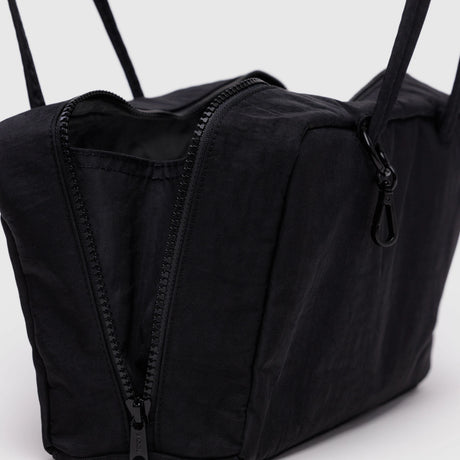 Close-up of the Baggu Nylon Bowler Bag - Black by Baggu, rectangular with a partially open zipper showing the interior and a strap clip. Made from recycled nylon for style and sustainability.