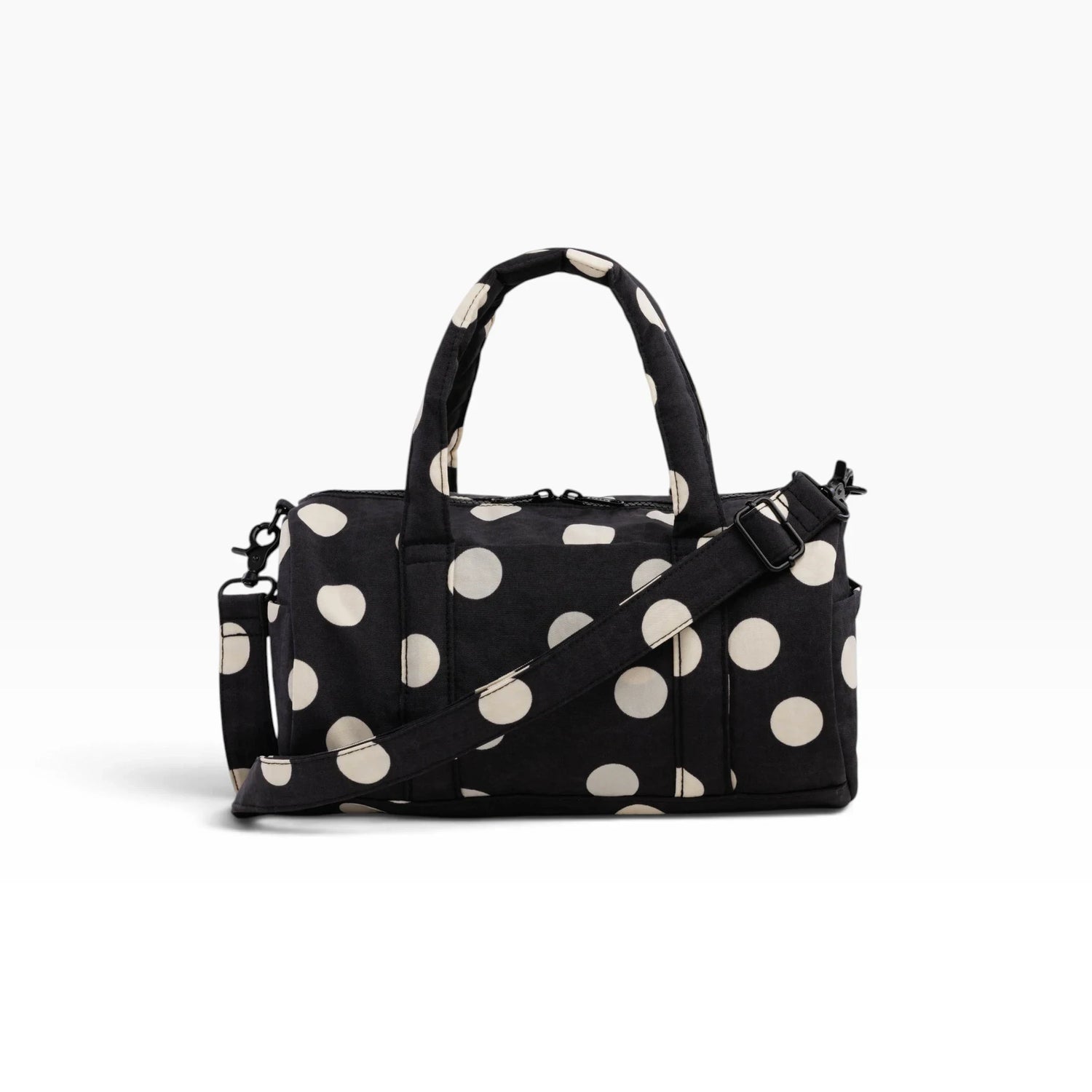 Black and cream polka-dot nylon duffle bag with top handles and crossbody strap
