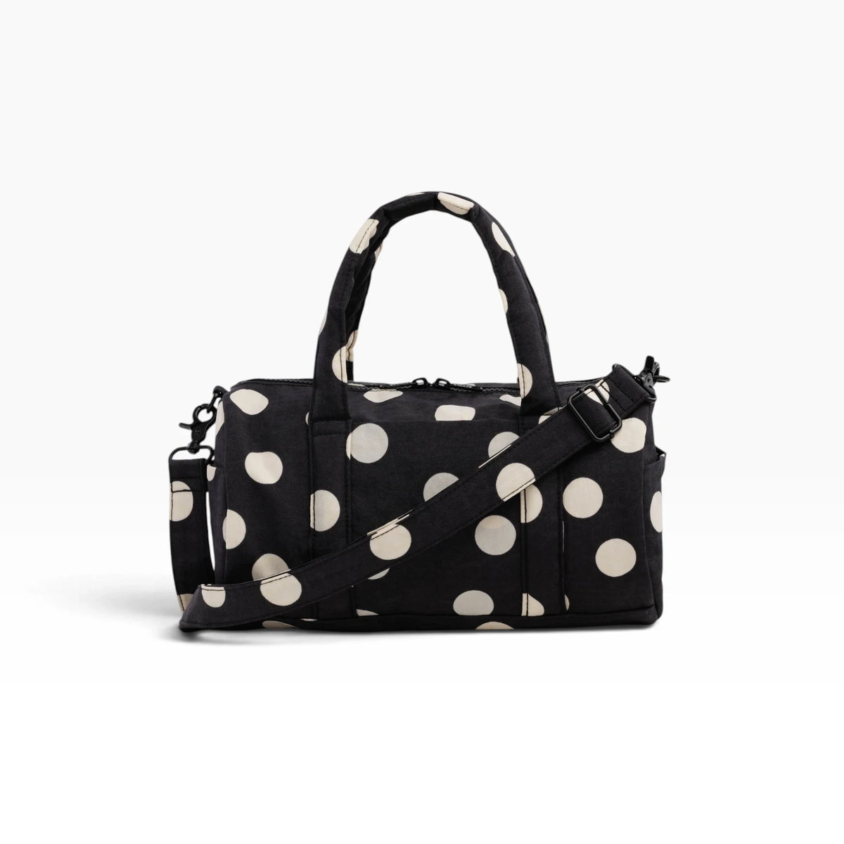 Black and cream polka-dot nylon duffle bag with top handles and crossbody strap