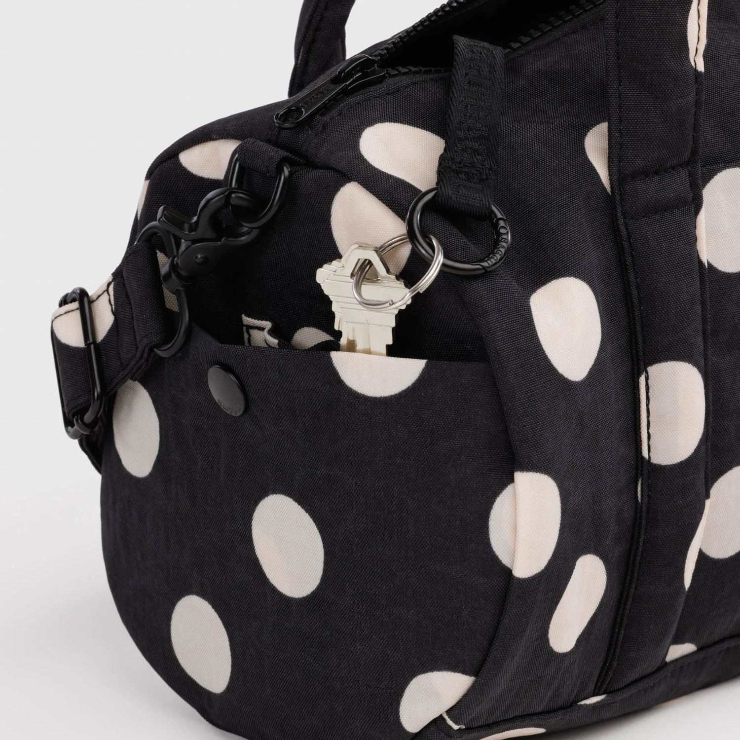 Polka-dot nylon duffle bag with front ring detail and zippered top