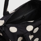 Polka-dot nylon duffle bag with zipper opening and black interior lining