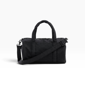 Black nylon duffle bag with top handles, shoulder strap, and zip closure