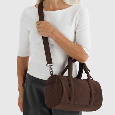 Coffee-brown nylon duffle bag with top handles and adjustable shoulder strap