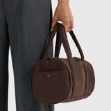 Coffee-brown duffle bag with round front pocket and top handle carry
