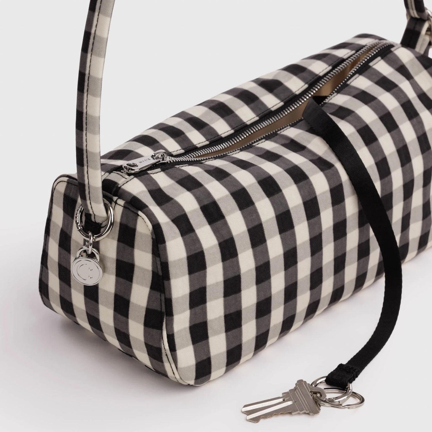 Gingham nylon bag with zip top, side strap, and key charm detail