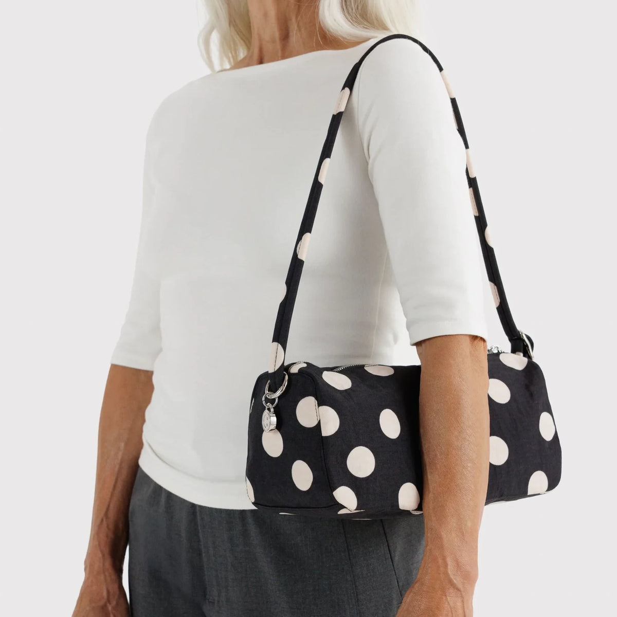 Baggu black and cream polka dot shoulder bag worn by model