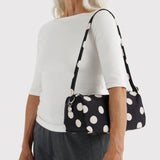 Baggu black and cream polka dot shoulder bag worn by model