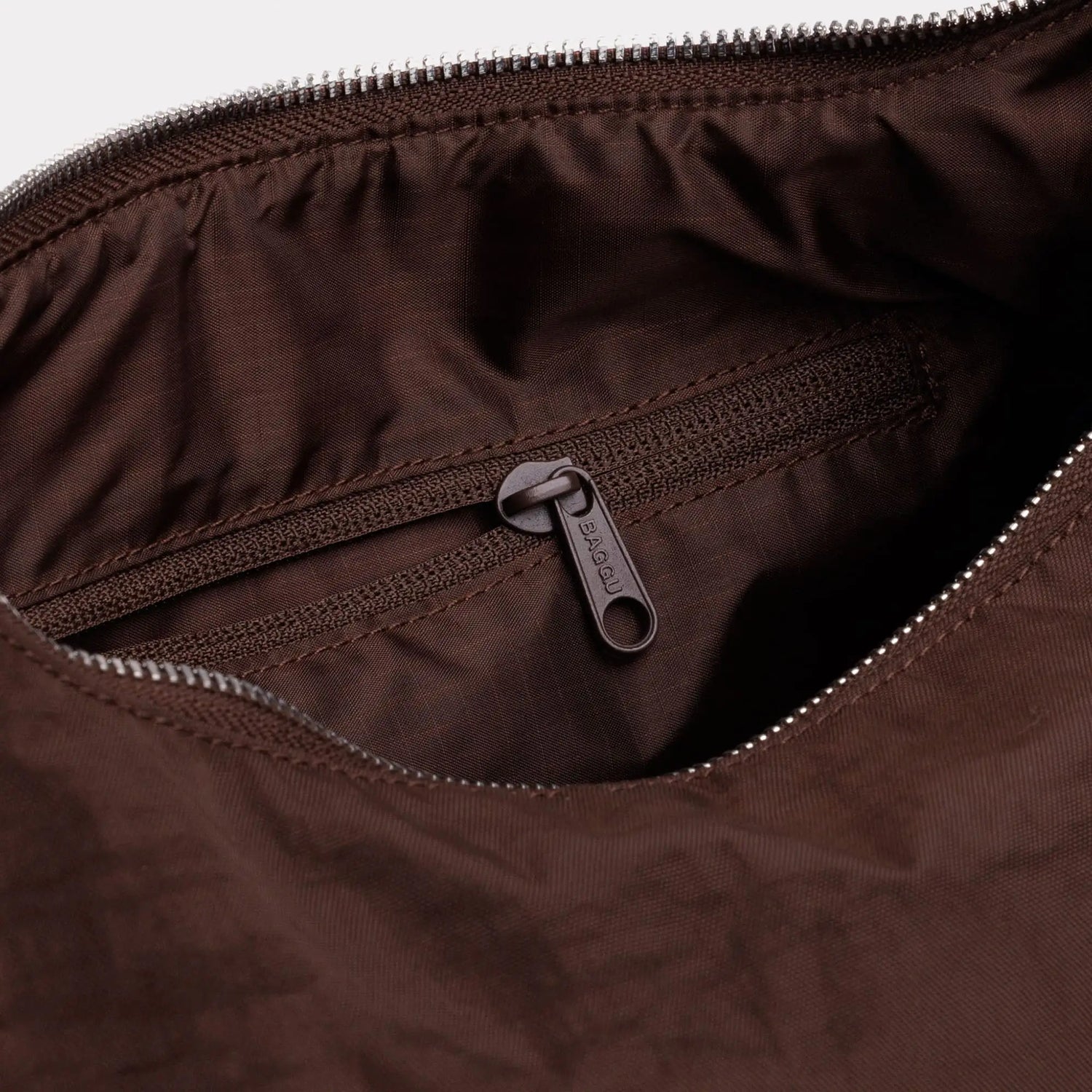 Nylon bag interior pocket with zipper, visible zipper pull
