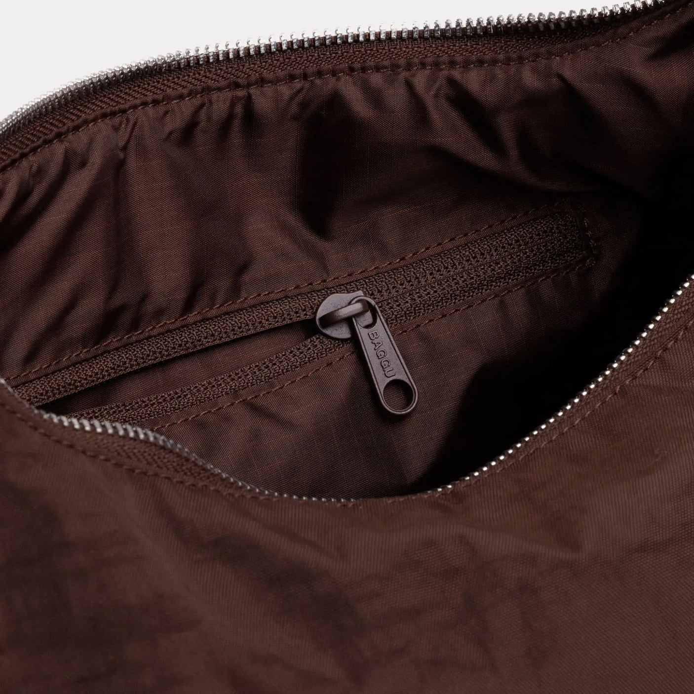 Nylon bag interior pocket with zipper, visible zipper pull