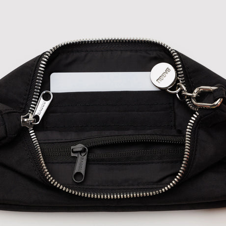 Black nylon pochette bag with front zip pocket, silver zipper, and logo patch
