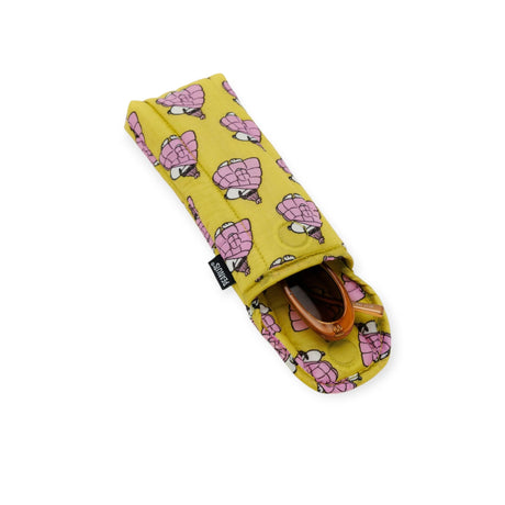 The Baggu Glasses Sleeve - Snoopy Mini Puffer is a charming yellow fabric accessory adorned with a playful pink turtle pattern. Partially open, it stylishly reveals its contents, reminiscent of a delightful Peanuts collaboration and adding charm to your daily essentials.