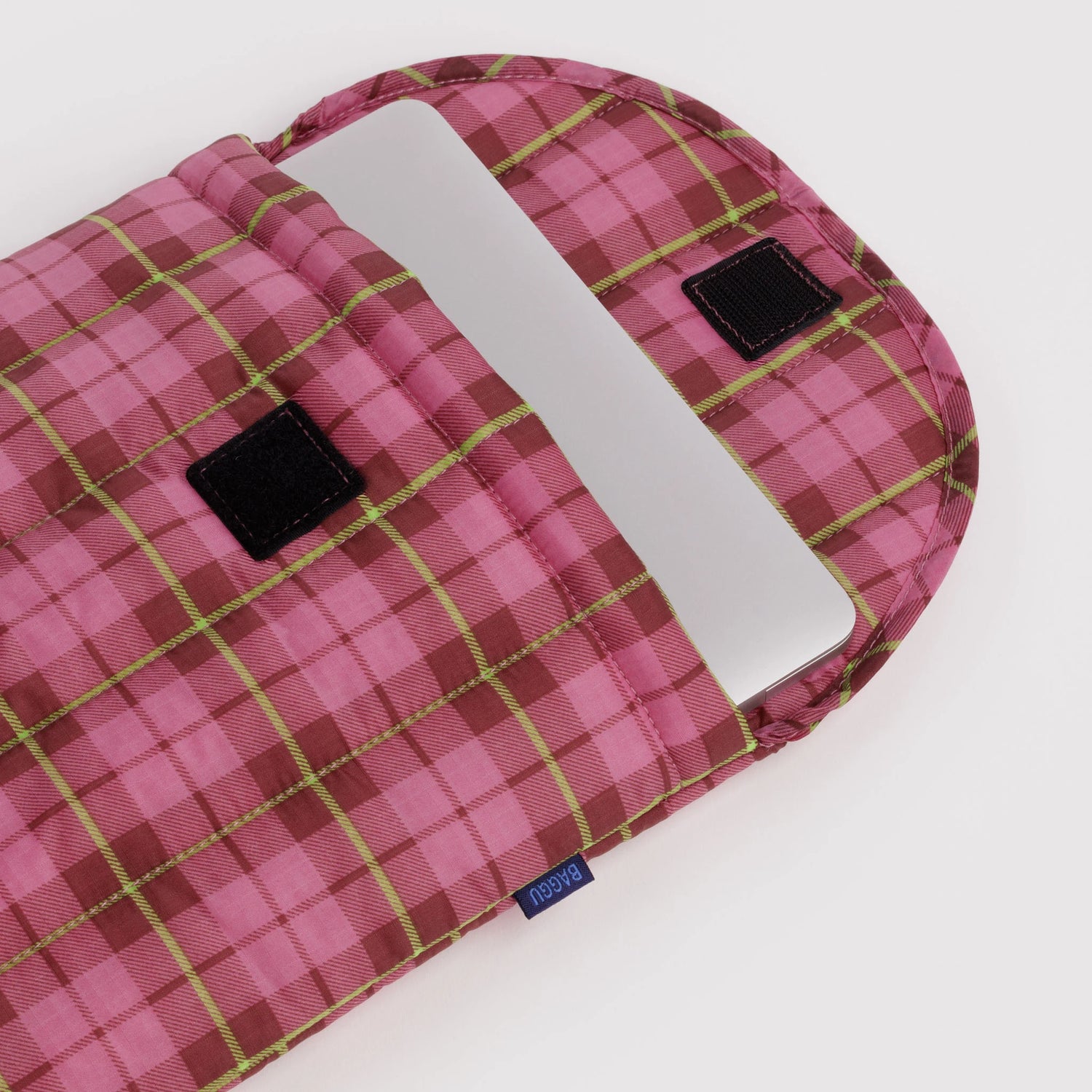 Baggu puffy laptop sleeve, pink plaid interior with elastic strap and label detail
