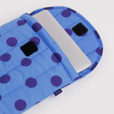 Puffy laptop sleeve flap with two black hook-and-loop tabs, blue purple polka dot