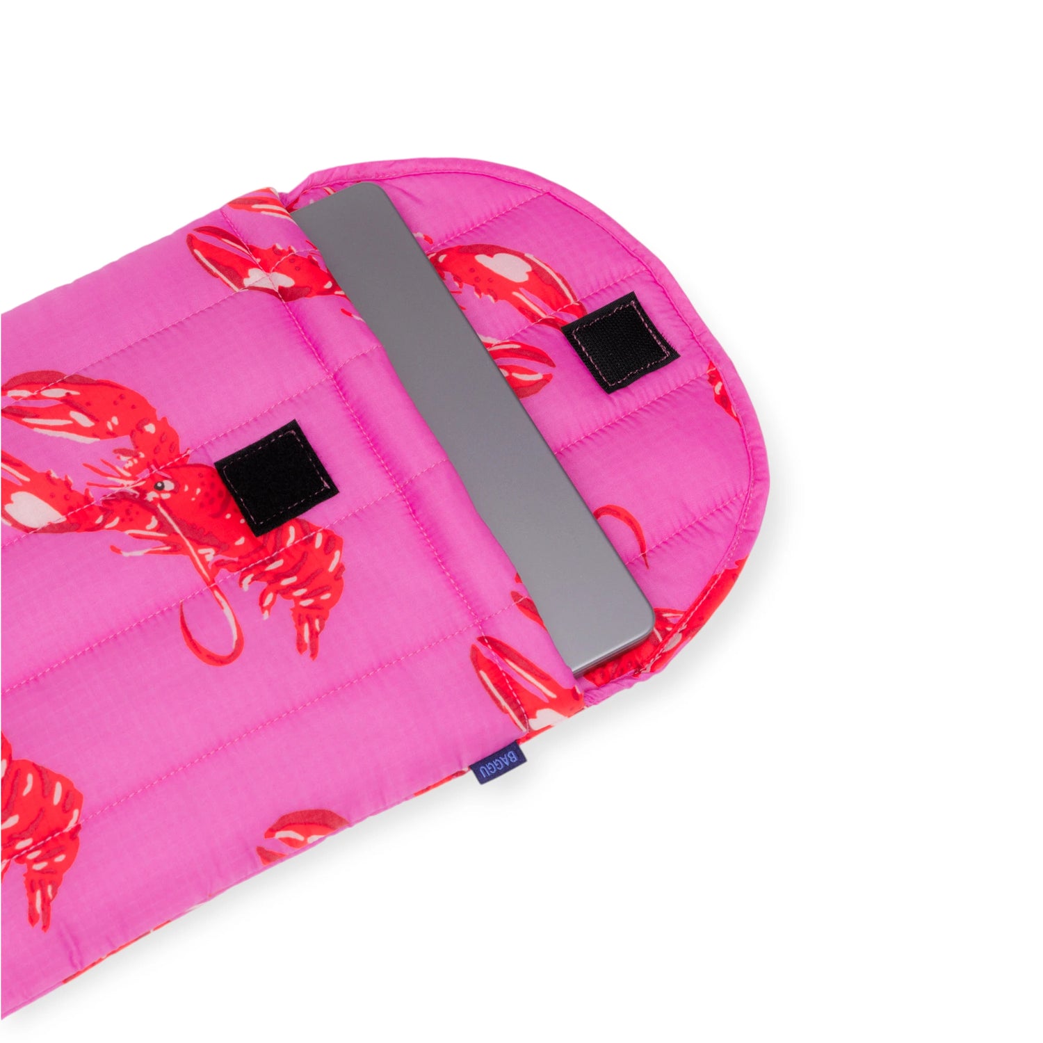Pink Baggu Puffy Laptop Sleeve with red lobster print and quilted padding holding a 13-inch laptop partially inside