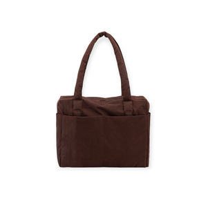 Brown fabric tote bag with two long padded handles and large exterior pocket on white background