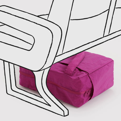 Bright pink fabric travel pouch with zipper and handle placed under airport seating illustration