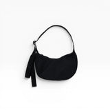 Black small nylon crescent bag with drawstring strap and tassel pull