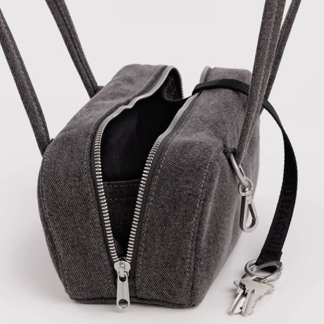 Washed black denim bowler bag with open top, black lining, dual zippers and key clip