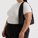 Black nylon small shoulder bag worn on one shoulder, open top design