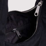 Black nylon small bag detail with silver zipper and interior pocket