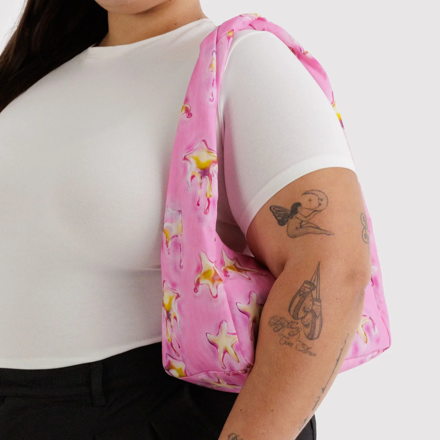 Pink nylon small hobo bag with star print, carried on shoulder