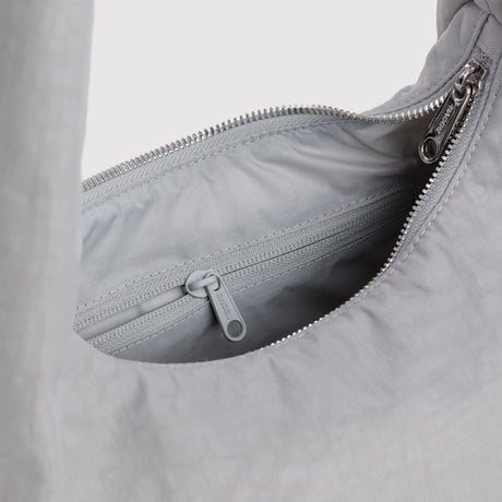 Interior of fog gray nylon tote with zippered top and gray cord pull tab