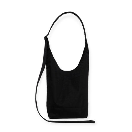 The Baggu Small Nylon Sling - Black by Baggu showcases a minimalist design, crafted from durable nylon and featuring a long, adjustable strap against a white background.