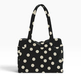Polka-dot tote bag in black with cream dots, top handles, roomy open shape