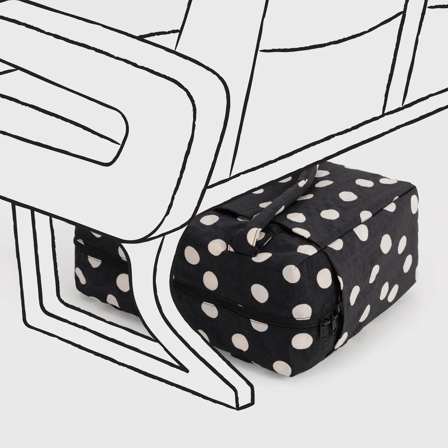 Black polka-dot bag with cream dots, rolled shape with tie strap detail