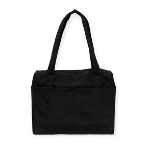 The Baggu Small Cloud Carry-on in black, crafted from recycled heavyweight nylon, features two long handles and a front pocket, displayed against a white backdrop.