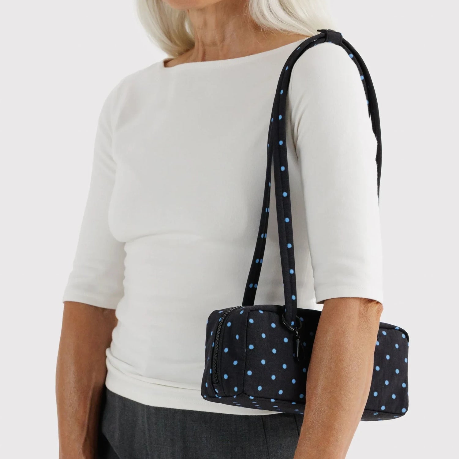 Small bowler bag with black and sky-blue micro dot print, crossbody shoulder straps