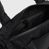 Black nylon duffle bag interior close-up with zip track and lining