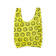 The Baggu Standard Reusable Bag in yellow showcases a cheerful smiley face design, reflecting its sustainable nature.