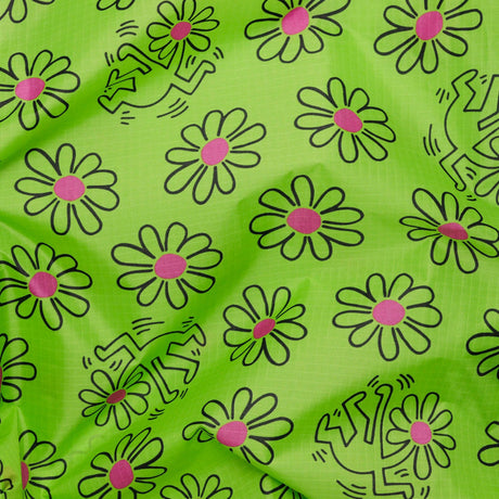 The Baggu Standard Bag - Keith Haring Flower showcases a green fabric decorated with daisies featuring purple centers and black line drawings of dancing figures, inspired by the iconic style of the Baggu x Keith Haring collaboration. Made from recycled nylon yarn, this bag is both stylish and eco-friendly for your everyday needs.