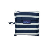 Folded striped fabric pouch crafted from recycled nylon, with a small handle on the side and labeled "Baggu," in a chic navy stripe design.