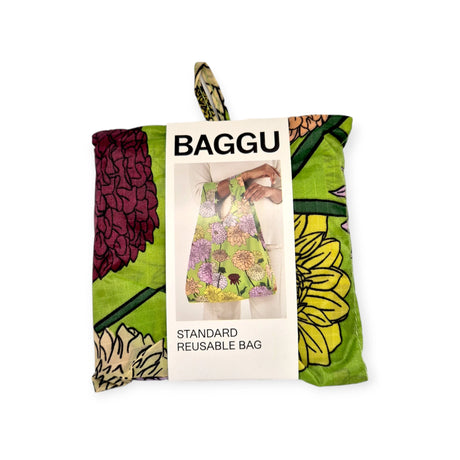 The Baggu Standard Reusable Bag - Dahlia, a sustainable option from Baggu, is made from recycled nylon and features a delightful floral design with green, purple, and yellow flowers.