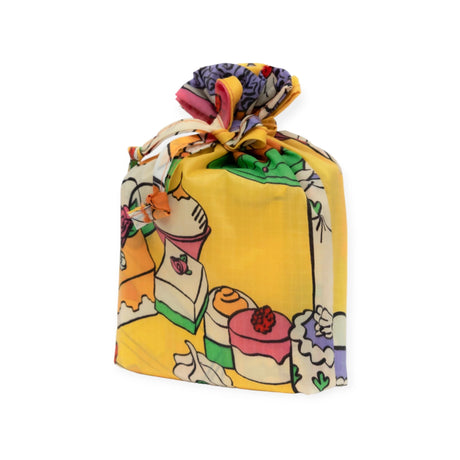 A vibrant and patterned gift bag from recycled nylon, showcasing a confectionery design, is part of the Baggu Set of 3 Standard Bags - Still Life. Tied at the top, this bag epitomizes sustainable style against a plain background.